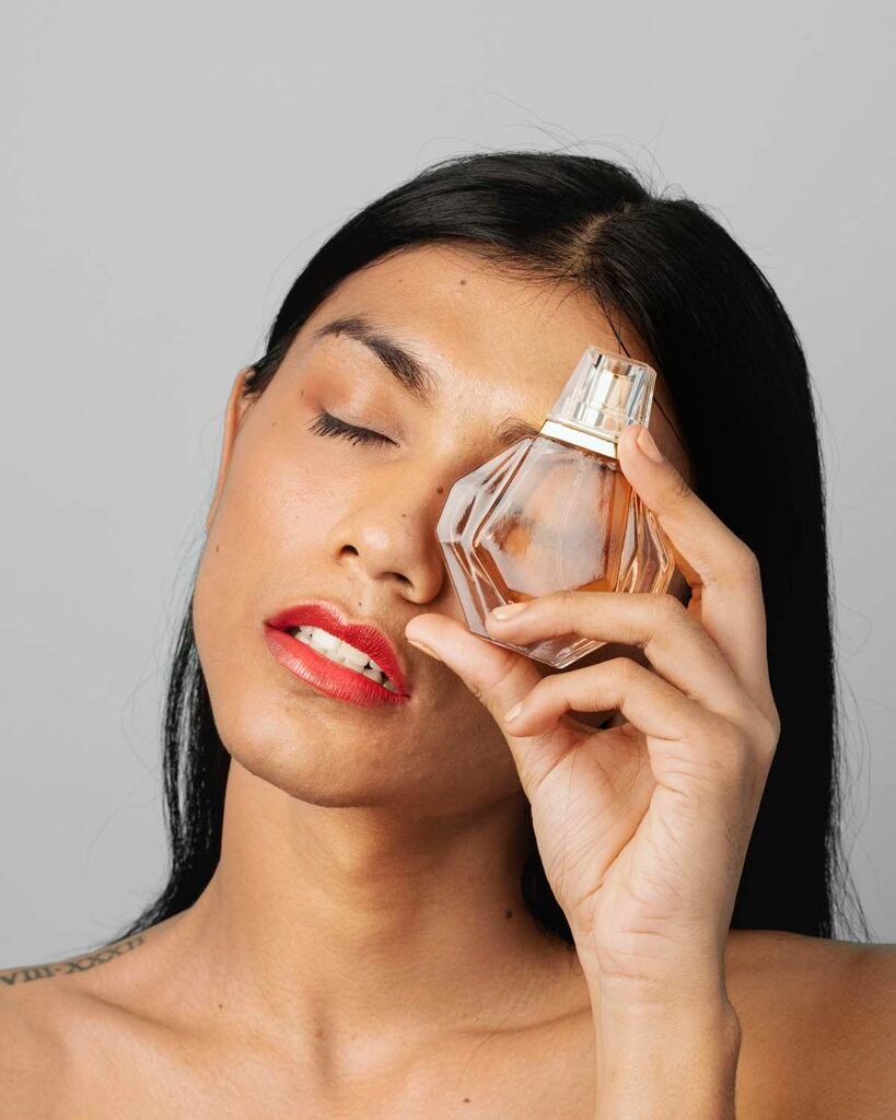 Woman holding a perfume glass bottle